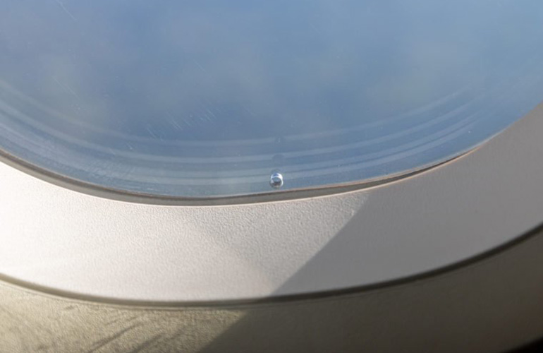 Why is there a hole in aeroplane windows?
