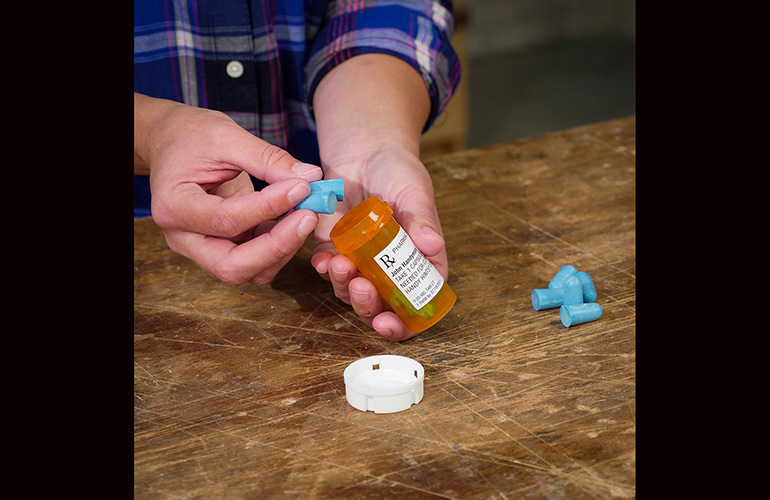 Use a medicine bottle for earplug storage