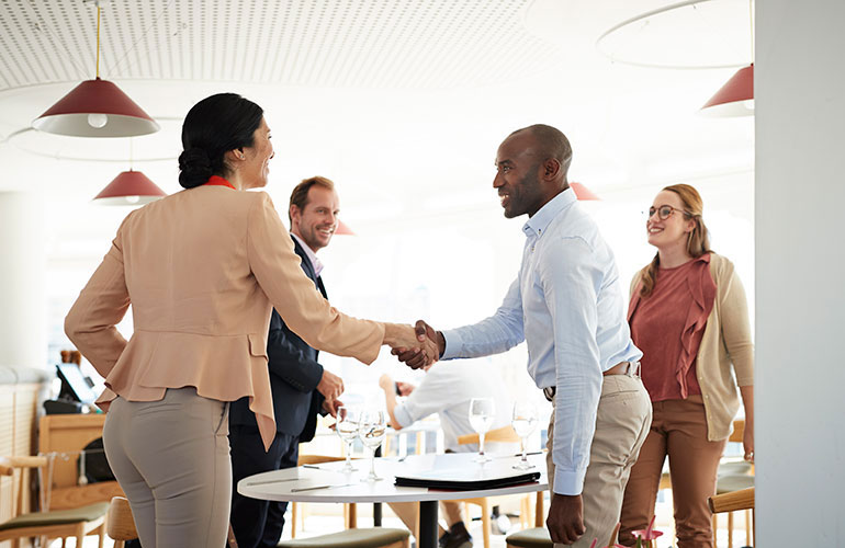 A man should stand to greet a woman