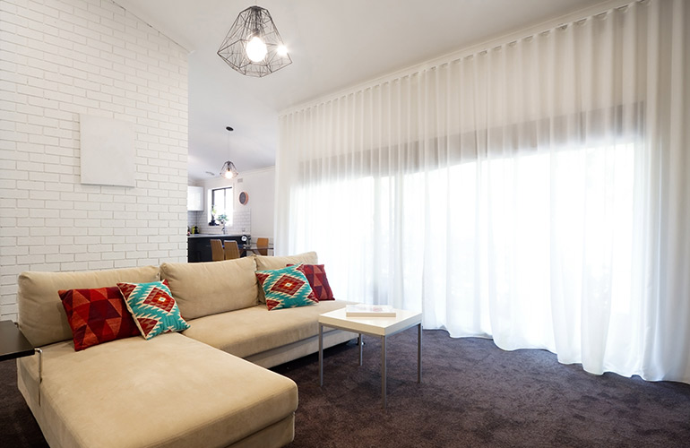 Sheer window treatments make a small room feel bigger