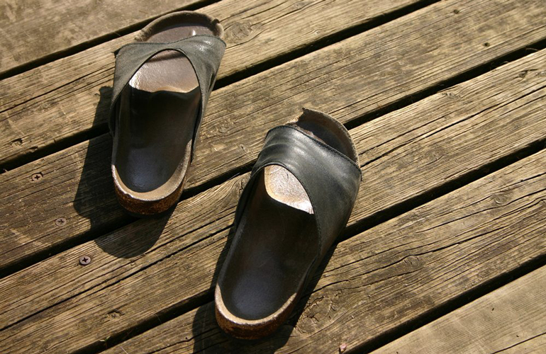 A green Birkenstock shoe (the right one)