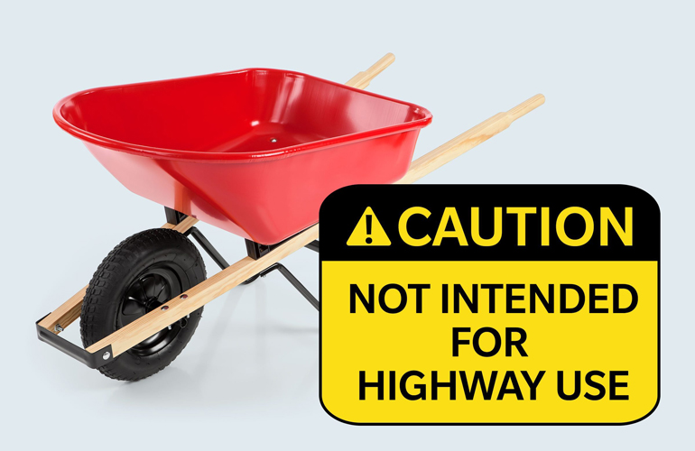 Warning label on a wheelbarrow: