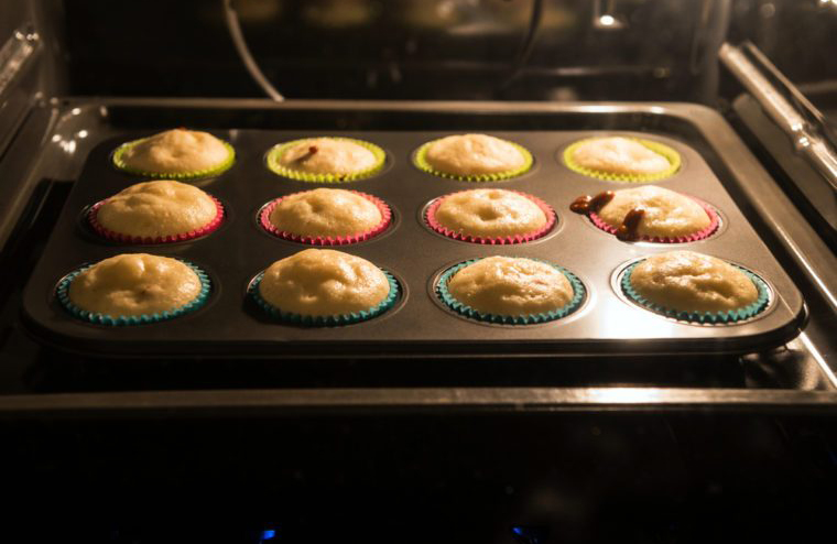Two muffins are sitting in the oven.