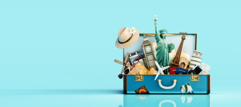 A suitcase packed with world landmarks, including the Eiffel Tower, Big Ben, and a Dutch windmill.