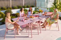 ladies sitting at an outdoor dining table having lunch