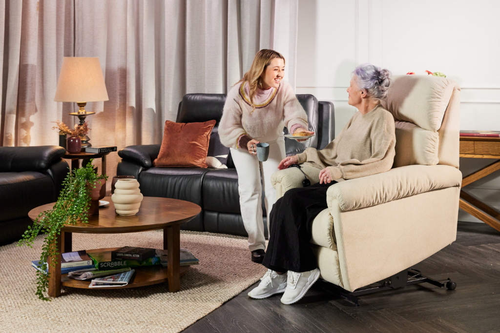 a senior sitting on lift chair talking to her daughter