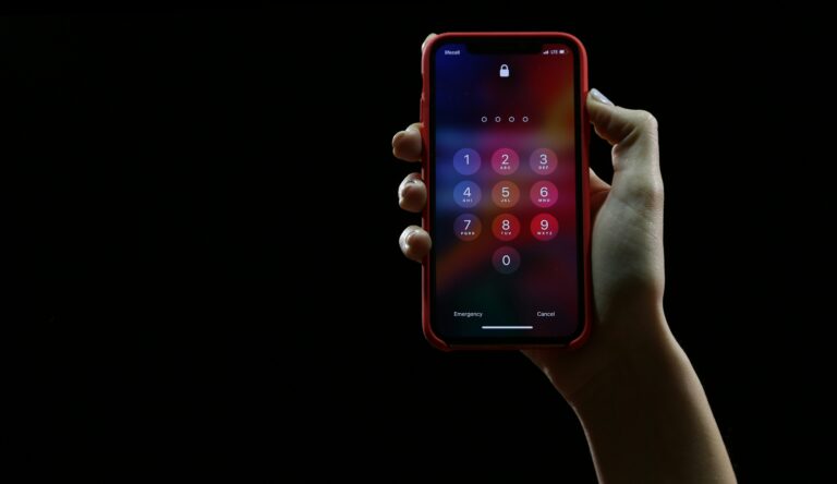 a hand holding a phone showing the passcode screen
