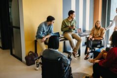 A group of university students collaborating and discussing a project