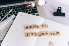 Health insurance spelled out with wooden letter tiles