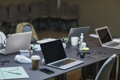 Laptops and office supplies on a shared desk