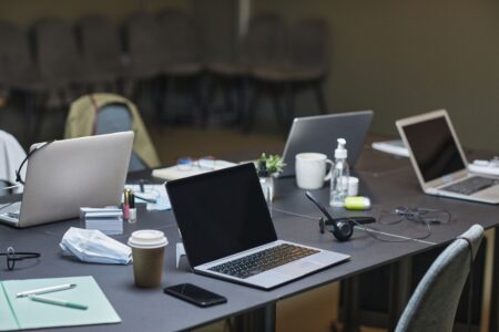 Laptops and office supplies on a shared desk