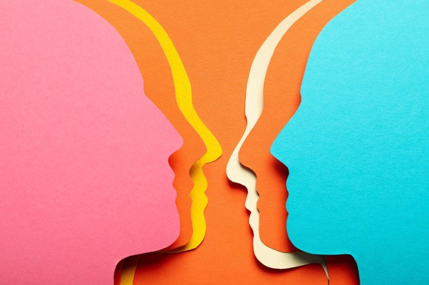 Colourful overlapping face silhouettes representing communication and mental health.