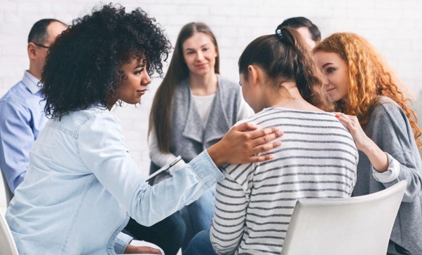 Women supporting each other during a group counselling session