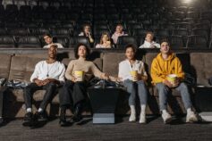 A group of young people watching a movie at the cinema