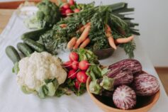Fresh cauliflower, carrots, radishes, cucumbers and eggplants.